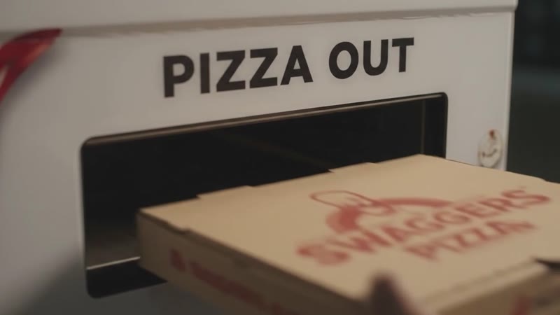 A Swaggers Pizza box sliding out of the Pizza Out slot